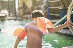 Kid about to swim in a pool